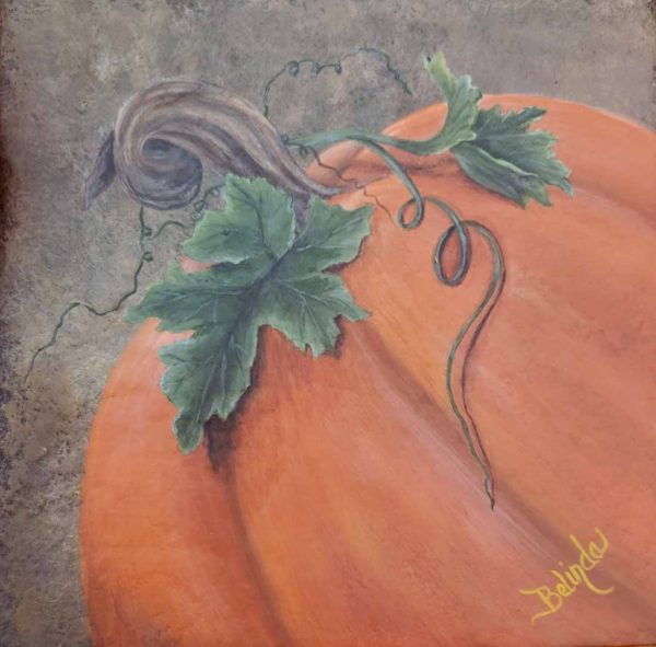 Featuring three-quarter view of a large orange pumpkin tilting to the left with two large green leaves and a vine that twists down the side of the pumpkin. The background is textured in colors of browns and blacks.