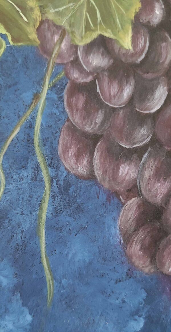 Painting of a lush grape cluster with green leaves against a deep blue background by artist Belinda Buckler