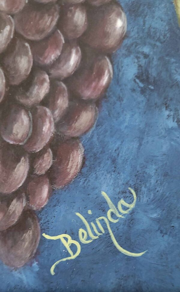 Painting of a lush grape cluster with green leaves against a deep blue background by artist Belinda Buckler